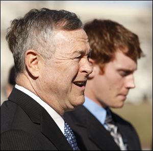 Rep. Dana Rohrabacher, R-Calif. speaks on behalf of accused Navy SEAL Matthew McCabe, right, to renew calls for exoneration of the 3 Navy SEALs charged in the alleged mistreatment of an Iraqi believed to be linked to the 2004 killings of four U.S. contractors.