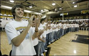 Jordan Jones, left, captain of the Northview High School hockey team joins teammates, fellow students and fans in cheering for the team during a pep rally at the school in Sylvania on Friday morning.