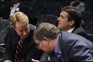 Attorneys Lane Williamson, left, and William Foster, right, confer as United Way president and CEO Bill Kitson listens during a meeting of the Toledo Plan Commission.