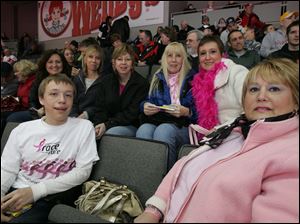 Cindy Rizzo, back row at right, attended the 'Pink on the Rink' Toledo Walleye game with her family, including son Zack Rizzo, 16, front row at left, and her sister, Chris Krzyminski, front right. Back row, from left, are Mrs. Rizzo's friends Colleen Wittenmyer, Renee Kane, Michelle Roberts, and Marianne Melton.