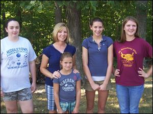 Cancer survivor Karla Batt, second from left, with goddaughters Jordan Soden, Hanna Schaffer, Madison Batt and Mikayla Batt at her 'No Chemo Party.'