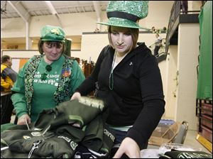Donna Strong, left, and her daughter Nicole Strong, sport Irish-themed clothing as they examine a vendor's wares at the annual celebration of St. Patrick and the Irish heritage.