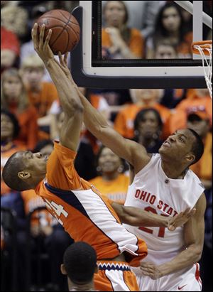 Ohio State's Evan Turner blocks a shot by Illinois' Mike Davis in the second half. Turner had 31 points and 10 rebounds for the Buckeyes who will play Minnesota for the Big Ten title Sunday.