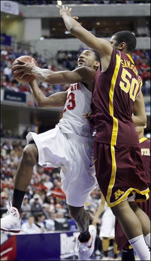 OSU's David Lighty spins away from Gopher defender Ralph Sampson III to score a driving layup.