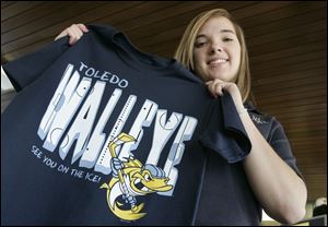 Notre Dame senior Sarah Kobylak of Rossford, left, holds her winning design for the Walleye T-shirt. 