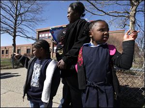 Chalkney Perry is with her children Ramondo Lewis, 4, left, and Treasure Lewis, 5, at Bunche school, which is on a list to close.
