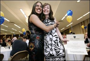 the blade/dave zapotosky
Sapna Shah of Detroit, left, embraces Katie Cabanski of Toledo after they learn they are both heading to Chicago for their residencies. Match Day was held yesterday at the Stranahan Theater.
