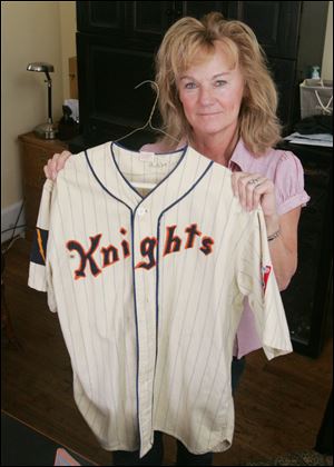 Barbara Shiff, who has done wardrobe work on films, displays a baseball jersey worn by Robert Redford in the movie 'The Natural.'