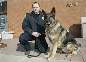 Barney, with handler Patrolman Fred Genzman, is one of two bomb-sniffing dogs in northwest Ohio. The dog lives with Patrolman Genzman and his family.