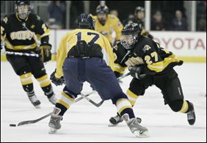 Northview's Zach Felser (27) sweeps the puck past a  Cleveland St. Ignatius player during the championship game.