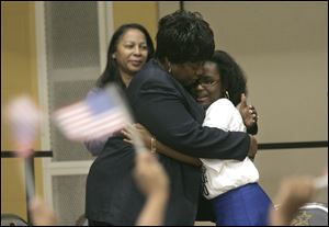 WilliAnn Moore, president of the Toledo NAACP, hugs Tayeana Willis, right, after Miss Willis sang ‘The Greatest Love of All.' In addition to the performances, students presented their creative writing projects, which dealt with the U.S. census.

