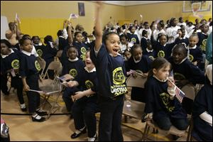 Happy students at the Ella P. Stewart Academy for Girls in Toledo including Jiliyah Easter, center, react after a surprise performance by the Zion City Drum Corps. The school, in conjunction with the Toledo Unit of the NAACP, hosted a ‘2010 Census Extravaganza' yesterday.