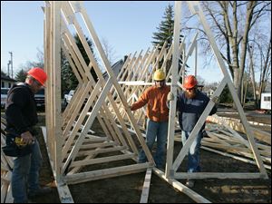 CTY build28p Frank Psurny, left; Don Dotson, and Jack Shapard (cq), all, of Swanton,  working on a truss. The Dotson Company [419.877.5776] is constructing housing for Mercy Outreach Industries IV, Inc. at 6934 Brint in Sylvania, Ohio on  Wednesday, March 24, 2010. They expect to be finished in late 2010. Jetta Fraser/Toledo Blade