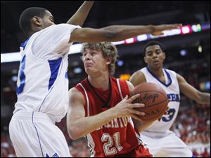 Port Clinton's Derek Colston is pressured by Dayton Dunbar's Ryan Bass, left, and Deontae Hawkins in the D-II state final.