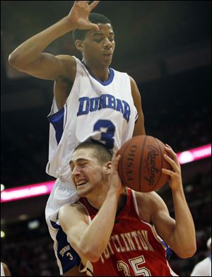 Port Clinton's Josh Francis, who had 12 points, drives against Dayton Dunbar's Deontae Hawksins
in Saturday's Division II state championship game at Value City Arena in Columbus.
