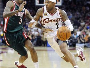 Cleveland's Mo Williams drives past Milwaukee's Brandon Jennings. He had 21 points for the Cavaliers.