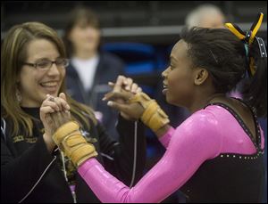 Perrysburg coach Michelle Nordhaus congratulates Chelsea Williams after her vault at the state meet.