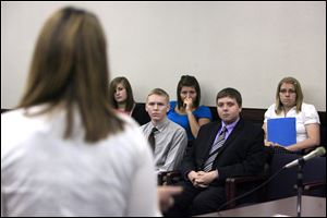 Jessica Walls, foreground, addresses a Teen Court jury that includes, front from left, Chris Woessner of Bowling Green High School and John Vrzal of Perrysburg High School and, back from left, Jessica McKenzie of Elmwood High School, Bre Hitchen of Lake High School, and Jane Powell of North Baltimore High School.