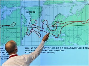 A member of the German Air Traffic Control Center crisis management group in Langen, near Frankfurt, points out the estimated size and direction of the ash cloud over Europe.