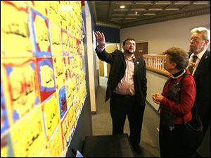 Slug:  CTY mulitfaith26p                                    Date 4/25/2010 Toledo Blade/Amy E. Voigt                Location: Toledo, OH  CAPTION:  Ammar Alo, left, from Toledo, points out features of a piece of artwork called "The 99 names of God" to Janice Wolff (cq), center, from Toledo, and Richard Hazle, right, from Perrysburg, during the  9th Annual MultiFaith Banquet at the Masjid Saad.