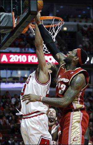 LeBron James, who had 37 points, blocks a shot by Chicago's Joakim Noah in Sunday's game.