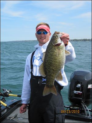 Ross Robertson holds an 8-pound smallmouth bass he caught last week.