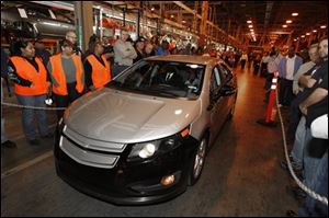 Dec. 7, 2009 file photo, a pre-production Chevrolet Volt is driven at the General Motors Hamtramck Assembly plant in December 2009 during a news conference in Hamtramck, Mich. General Motors Co.