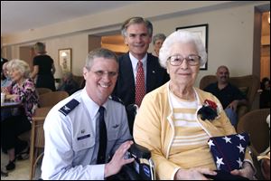 Col. Mark Bartman, commander of the 180th Fighter Wing, left, and Rep. Bob Latta present Leona 'Le' Zimmer, 89, with a Congressional Gold Medal for her service during World War II.