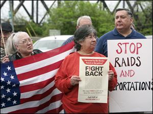Connie Eason, left, Martha Delgaso, and Jesus Salas march for immigration reform in downtown Toledo. Two Toledo groups organized the rally before marching in Detroit's Mexican Town.