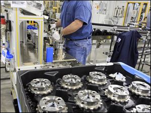 Toledo Powertrain employee Mike Saylor runs tests to prepare for production of a new front-wheel-drive transmission.