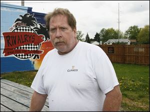 Dale Hilkens, who tends bar at Rivalry's in Bedford Township, says customers who
want to smoke have been going outside and the new law ‘has not been a problem.'