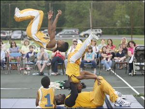 Slug: CTY acrobats03p                               Date 5/02/2010 Toledo Blade/Amy E. Voigt                Location: Toledo, Ohio  CAPTION:  Drashun(cq) Wilson, with The Chicago Boyz Acrobatic Team,flips over his teammates in an acrobatic feat  in honor of the holiday Lag B'Omer at the Jewish Community Center on Sunday on May 2, 2010. The event was sponsored by the Chabad House of Toledo and The Friendship Circle.