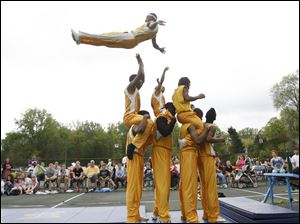 Slug: CTY acrobats03p                               Date 5/02/2010 Toledo Blade/Amy E. Voigt                Location: Toledo, Ohio  CAPTION:  Lindsay Scheinbach(cq), from Sylvania Township, back, and Isabelle VanDyke, 6, from Toledo, front, watch The Chicago Boyz Acrobatic Team perform in honor of the holiday Lag B'Omer at the Jewish Community Center on Sunday on May 2, 2010. The event was sponsored by the Chabad House of Toledo and The Friendship Circle.