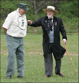 Read 'Steamboat' Backus, left, talks with Bruce Wharram, the judge (a position now called umpire). Mr. Backus has been on the Frogs team 19 years. 'It's a different kind of base ball,' he says. 'You get to be with friends, and you make friends.'