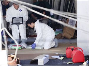 FBI agents examine items in a garage in Faisal Shahzad's hometown, Bridgeport, Conn. He was arrested Monday on charges that he drove a bomb-laden SUV to Times Square Saturday.