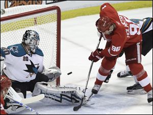 Detroit's Tomas Holmstrom puts the puck past San Jose goalie Evgeni Nabokov but the Sharks rallied from a 3-1 deficit to win.