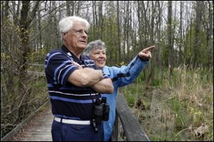 John Mang and Rita Beckman of Oregon watch at Maumee Bay State Park for birds like a red-winged blackbird, below.
