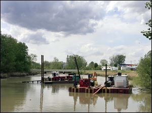 A dredge works the Ottawa River near Stickney Avenue.