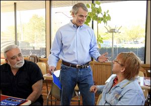 Rob Portman, center, discusses his U.S. Senate campaign with Anton Aringer and Betty Osenbaugh.
