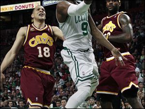 Rajon Rondo drives past Cleveland's Anthony Parker, left, and LeBron James in Game 4 of the Eastern Conference semifinals. Rondo is the third player in playoff history to have at least 29 points, 18 rebounds, and 13 assists.