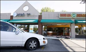 Slug:  CTY crash                             Date 5/9/2010 Toledo Blade/Amy E. Voigt                Location: Toledo, Ohio  CAPTION:   The white Honda which crashed through Checksmart at 4550 Monroe Street on May 9, 2010.