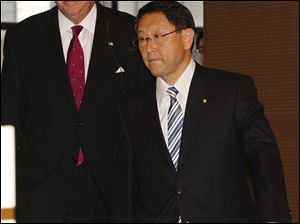 U.S. Transportation Secretary Ray LaHood and Toyota President Akio Toyoda arrive for a news conference in Toyota City, Japan.