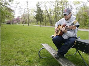 With no pretensions of becoming the next ‘American idol,' Randy Curtis of Defiance practices the guitar at Independence Dam State Park in Defiance.
