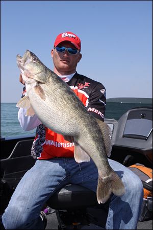 Toledo fishing guide Ross Robertson shows off the 15.1 pound walleye that he pulled from Lake Erie.