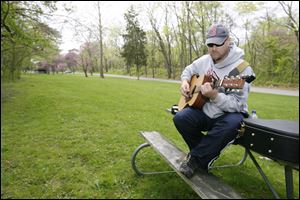 With no pretensions of becoming the next ‘American idol,' Randy Curtis of Defiance practices the guitar at Independence Dam State Park in Defiance.
