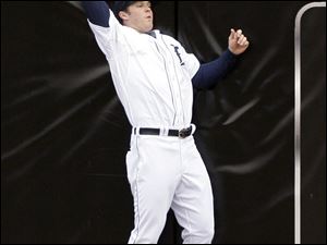 Detroit right fielder Brennan Boesch
catches a ball at the wall hit by the Yankees' Alex Rodriguez. The Tigers' Rick Porcello pitched seven innings,
giving Detroit's taxed bullpen a break.