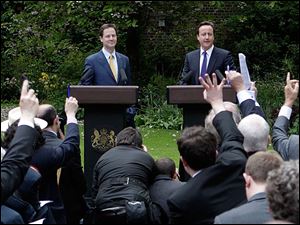 New British Prime Minister David Cameron, right, and Deputy Prime Minister Nick Clegg hold their first joint press conference.