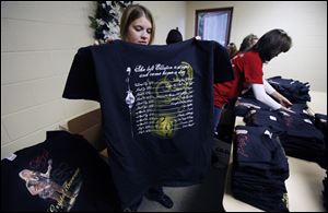 Janene Gahler of Elliston folds Crystal Bowersox T-shirts at Trinity United Church of Christ, where the singer-songwriter's fans gather every Wednesday night to watch ‘American Idol.'
