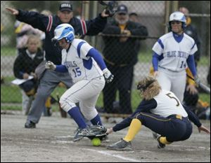 Springfield's Jesse Zappone scores as Notre Dame catcher Jenna Inman tries to pick up the ball in yesterday's
Division I sectional final. The Blue Devils improved to 17-6.