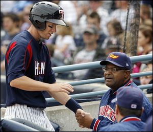 Toledo's Jeff Frazier is congratulated by coach Leon Durham after scoring a run in the fourth against Indianapolis at Fifth Third Field.